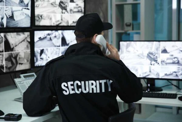Security officer monitoring CCTV cameras in a control room for Al Saqib Recruitment Agency