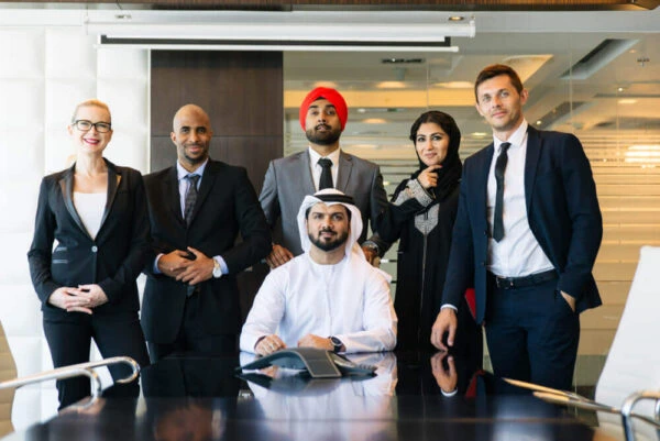 Diverse team of UAE business professionals in a modern office meeting room